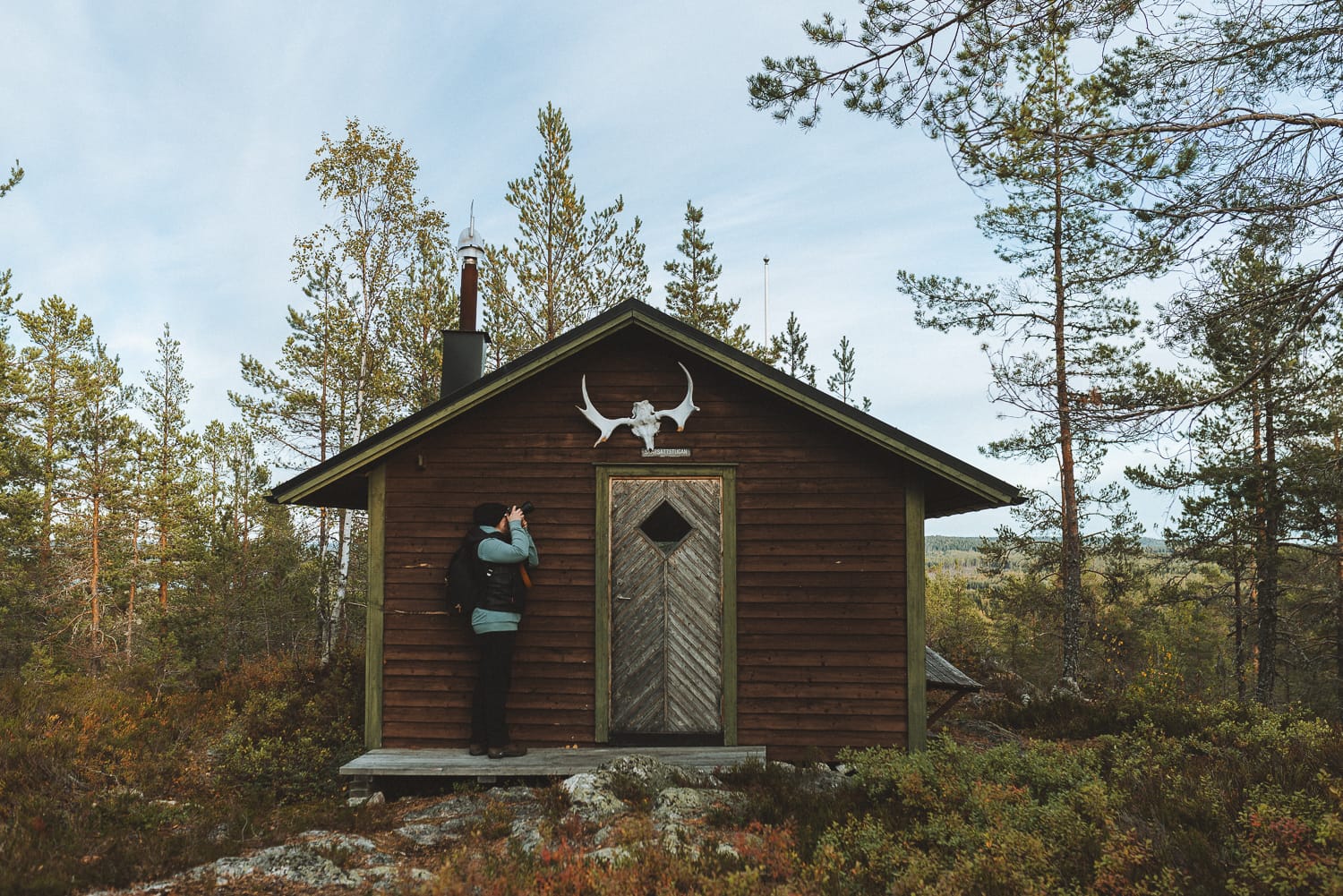 photographer by a cabin